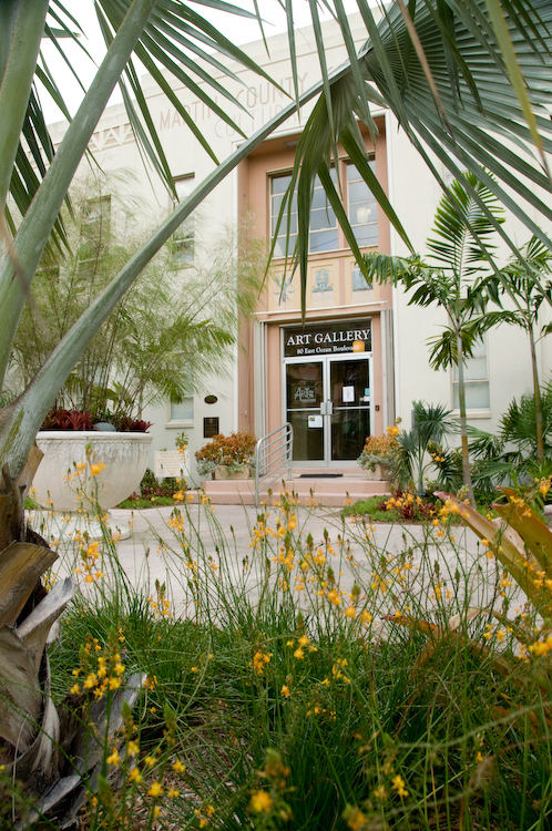 the art gallery viewed through some bushes