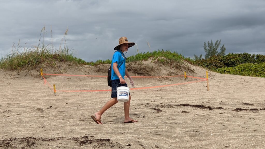 man with bucket on the beach