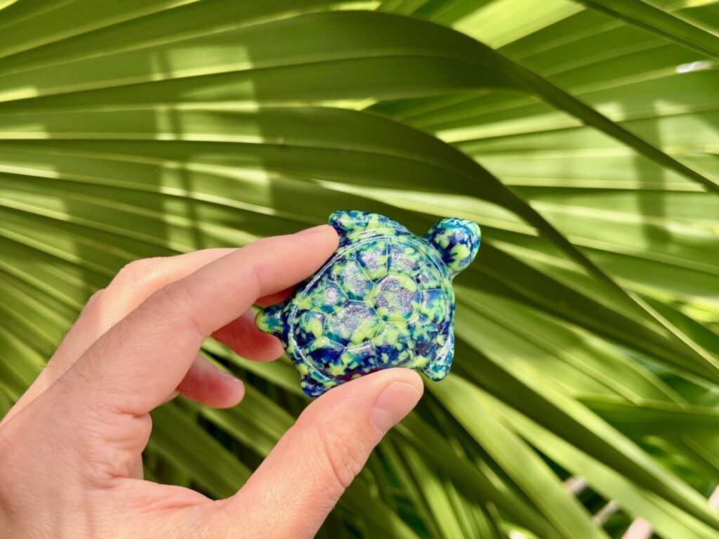 One of the 40 limited edition blue and green speckled glass sea turtles, part of the annual ArtsFest Hidden Turtles Scavenger Hunt